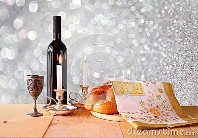 Sabbath image. challah bread and candelas on wooden table. glitter overlay Stock Photo