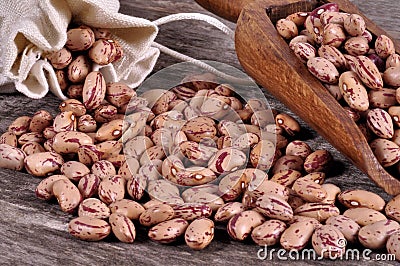 Sack of mix beans spill beans with beans on wooden table Stock Photo