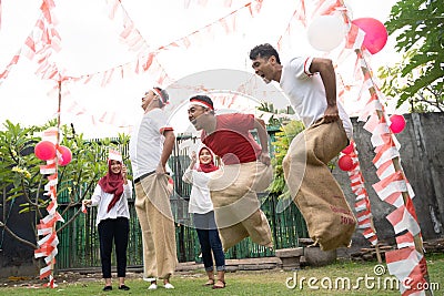 Sack race participants jumped each other by jumping to quickly reach the finish line Stock Photo