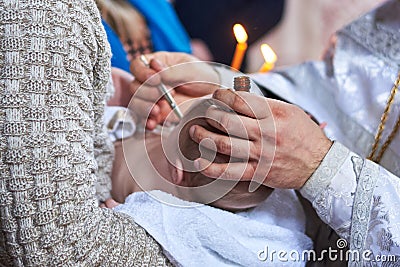 The sacrament of the baptism of the child in the Orthodox Church, the anointing Stock Photo