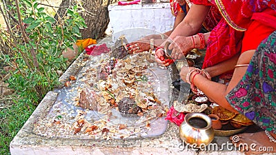 Sacred food with milk holding on Hindu god statue. Delicious Parsad for Hindu goddess Shilta Mata Stock Photo