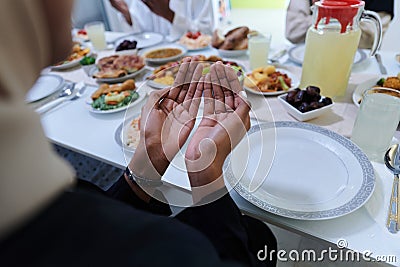 In the sacred month of Ramadan, a diverse Muslim family comes together in spiritual unity, fervently praying to God Stock Photo