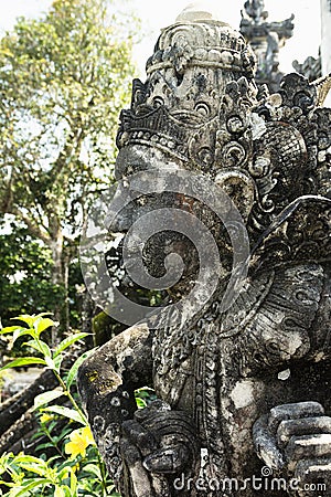 Sacred sculpture of human deity carved of stone decorate of traditional balinese sacred temple Lempuyang on Bali, vertical. Stock Photo