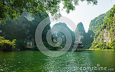 Sacred temple on the lake, sorrounded by mountain at Trang An Stock Photo