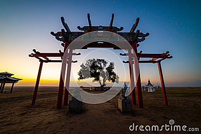 The sacred tree in Kalmykia. Silhouette of a gate or arch at the entrance to the cult object Stock Photo