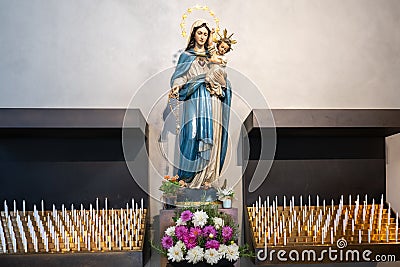 Virgin Mary with Son Jesus about sacrificial candles in Church of Bressanone, - Brixen - in Alto Adige, South Tyrol, Italy Stock Photo