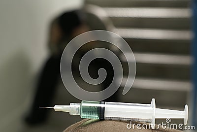 Sad addict and syringe Stock Photo