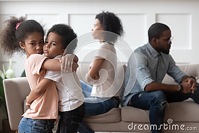 Sad african children embracing upset at parents fight at home Stock Photo