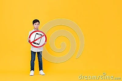 Sad Asian boy holding banned cellphone signage Stock Photo