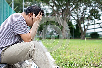 Sad Asian Chinese Man with face in hands Stock Photo