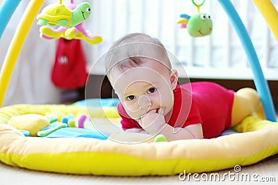 Sad baby on playmat Stock Photo