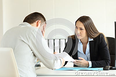 Sad boss firing an employee at office Stock Photo