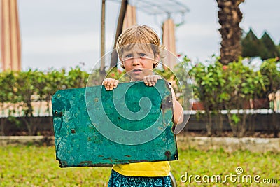 Sad boy standing with empty horizontal blank in hands Stock Photo