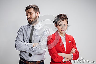 The sad business man and woman conflicting on a gray background Stock Photo