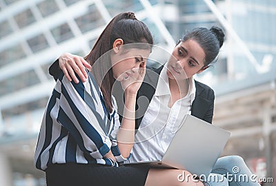 Sad business woman getting help from a friend Stock Photo