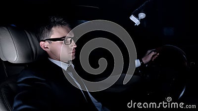 Sad businessman sitting in car near girlfriends house, hesitating to make call Stock Photo