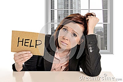 Sad businesswoman in stress at office work asking for help sitting frustrated Stock Photo