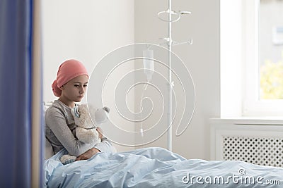 Sad child with cancer in the hospital with drip Stock Photo