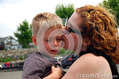 Sad child comforted by mother Stock Photo