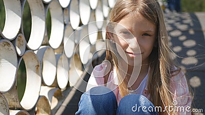 Sad Child in Park, Unhappy Thoughtful Girl Outdoor, Bored Pensive Kid on Bridge Stock Photo