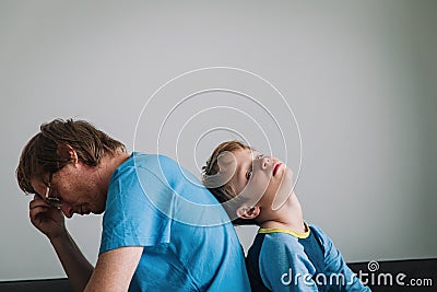 Sad child with stressed father staying home Stock Photo