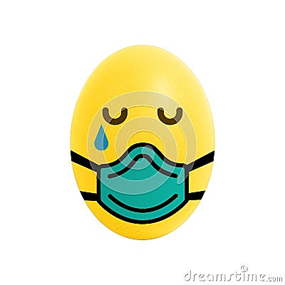 Sad and crying Yellow Easter Egg with a doctor mask Stock Photo