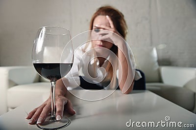 Sad depressed alcoholic drunk woman drinking at home in housewife alcohol abuse and alcoholism Stock Photo