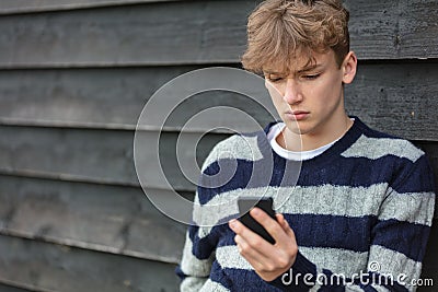 Sad Depressed Boy Male Child Teenager Using Mobile Cell Phone Stock Photo