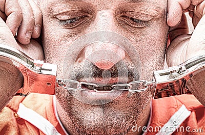 Sad depressed detained man with handcuffs in prison Stock Photo