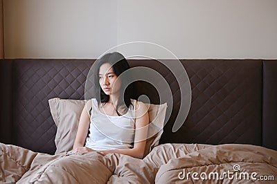Sad depressed woman thinking on bed in luxury bedroom Stock Photo