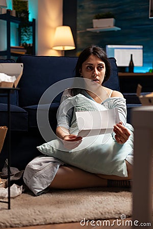 Sad desperate woman worrying about eviction notice debt Stock Photo