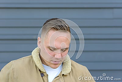 Sad despondent young man with downcast eyes Stock Photo