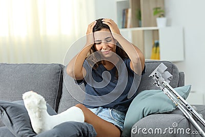 Sad disabled woman with plaster foot complaining Stock Photo