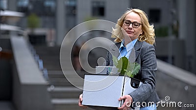 Sad dismissed business woman holding stuff box, unprofessional worker, failure Stock Photo