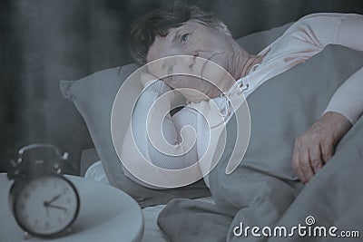 Elderly woman trying to sleep Stock Photo