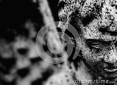 Sad eyes of angel of death . Black and white image. Fragment of ancient statueas symbol of pain and end of life Stock Photo