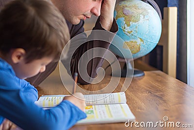 Sad father tired about helping son in mathematics homework Stock Photo