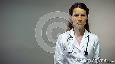 Sad female doctor looking into camera, melanoma awareness, disease level Stock Photo