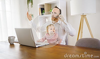 sad and frustrated father in kitchen home office with computer and her daugher Stock Photo