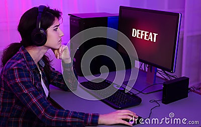 Sad gamer lost game, playing online on computer Stock Photo