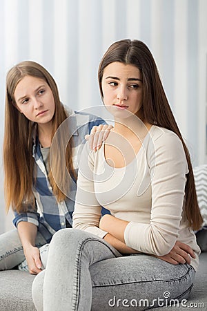 Sad girl comforted by her friend Stock Photo