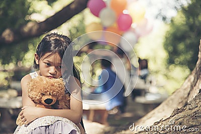 Sad girl feeling alone in the park concept.Lonely beautiful toddler girl stay alone in the park Stock Photo