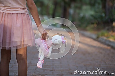 Sad girl hugging teddy bear sadness alone in green garden park. Lonely girl feeling sad unhappy walking outdoors with Stock Photo