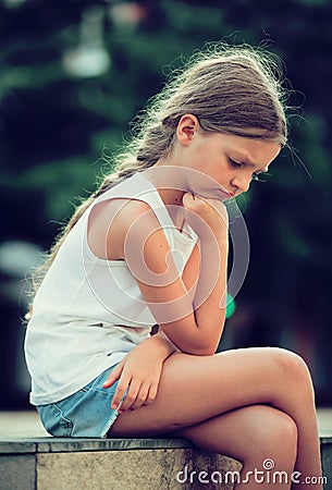 Sad girl outdoors Stock Photo