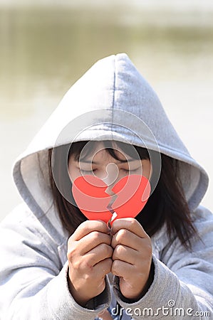 Sad Girl Praying to Reconcile from Red Broken Heart Stock Photo