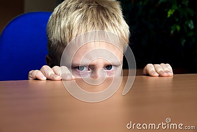 Sad kid hiding Stock Photo