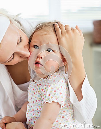 Sad little baby girl comforted by her mother Stock Photo