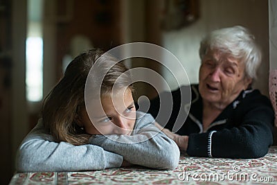 A little girl is comforted by her grandmother Stock Photo