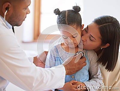 Sad little girl at doctors office. Sick girl sitting with mother while male paediatrician listen to chest heartbeat Stock Photo