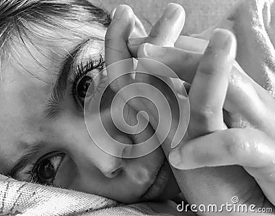 Sad little girl laying down Stock Photo